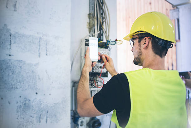 Electrician An electrician fixing up the wires and measuring volts phone repair stock pictures, royalty-free photos & images