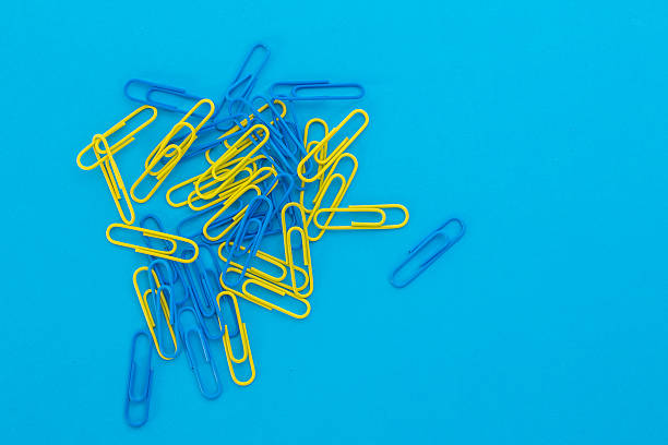 istock blue and yellow paper clips on a blue background 522540934