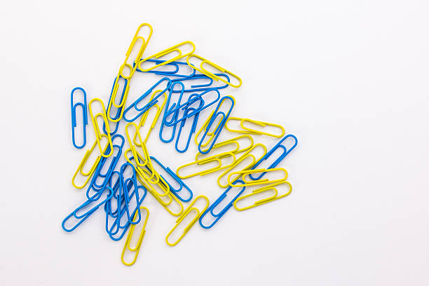 istock blue and yellow paper clips on a white background 522541000