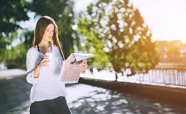 istock woman reading the newspaper and drinking coffe 522541042