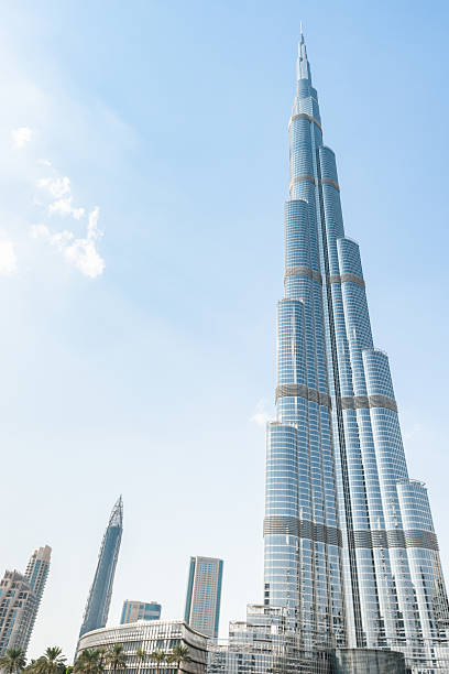 Dubai, UAE - October 30, 2014: Wide view of the new Dubai skyline downtown district around the tallest world building the Burj Khalifa tower with his all length. Sunny day.