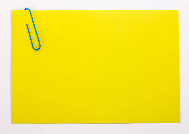 istock yellow sheet of paper with a blue clip 522541744