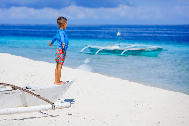 istock Boy in boat on the beach 522541836