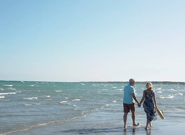 istock Romantic Senior Couple Walking On Beach 522543499