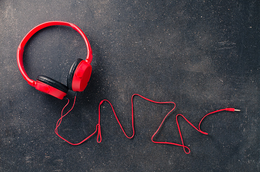 Red headphones on dark background