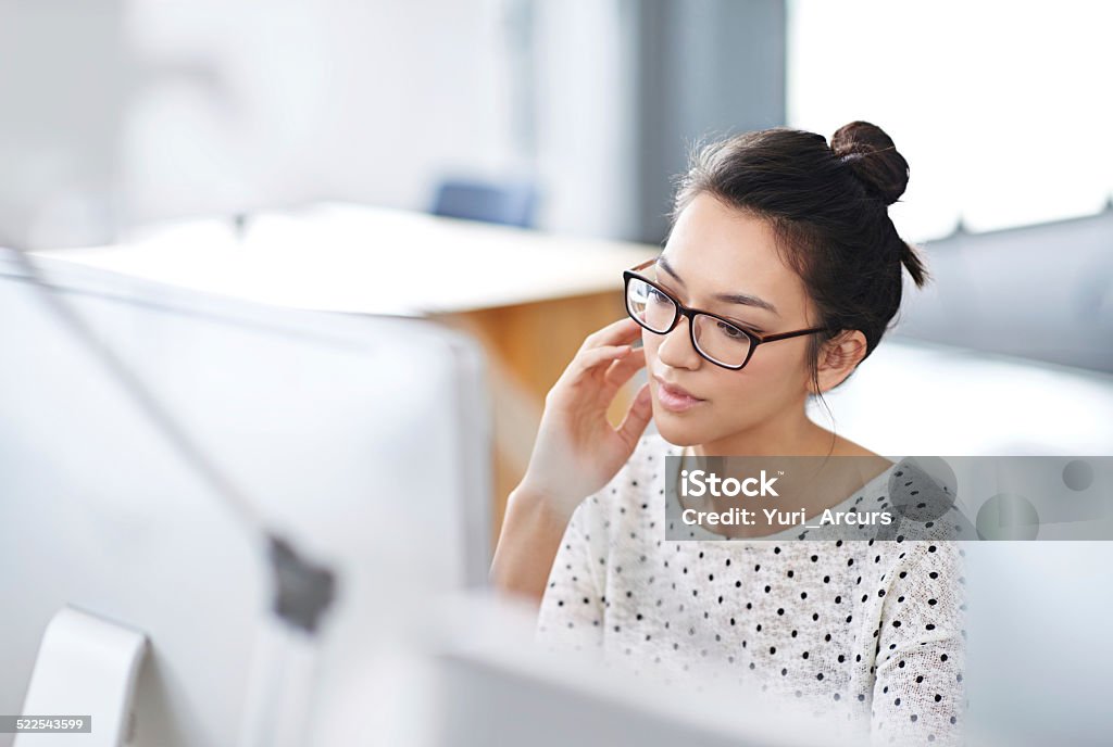 Trouble shooting tech is my specialty Shot of a young office worker sitting at her workstation in an office Computer Programmer Stock Photo