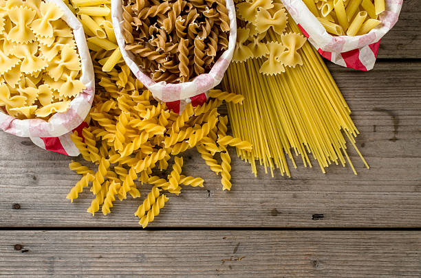 istock Pasta in paper bag on wooden table 522543898