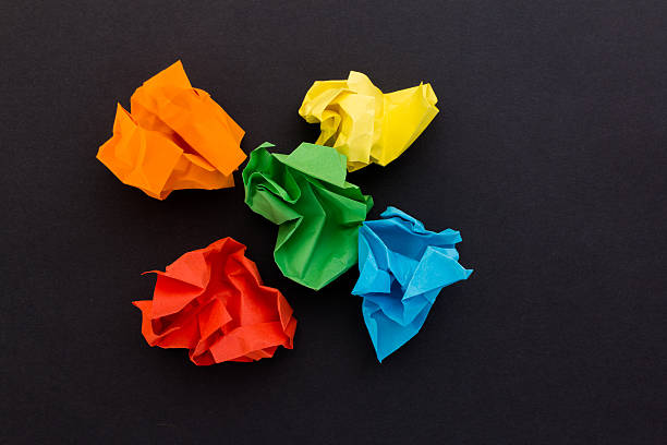 istock crumpled sheets of colored paper on a black background 522543926