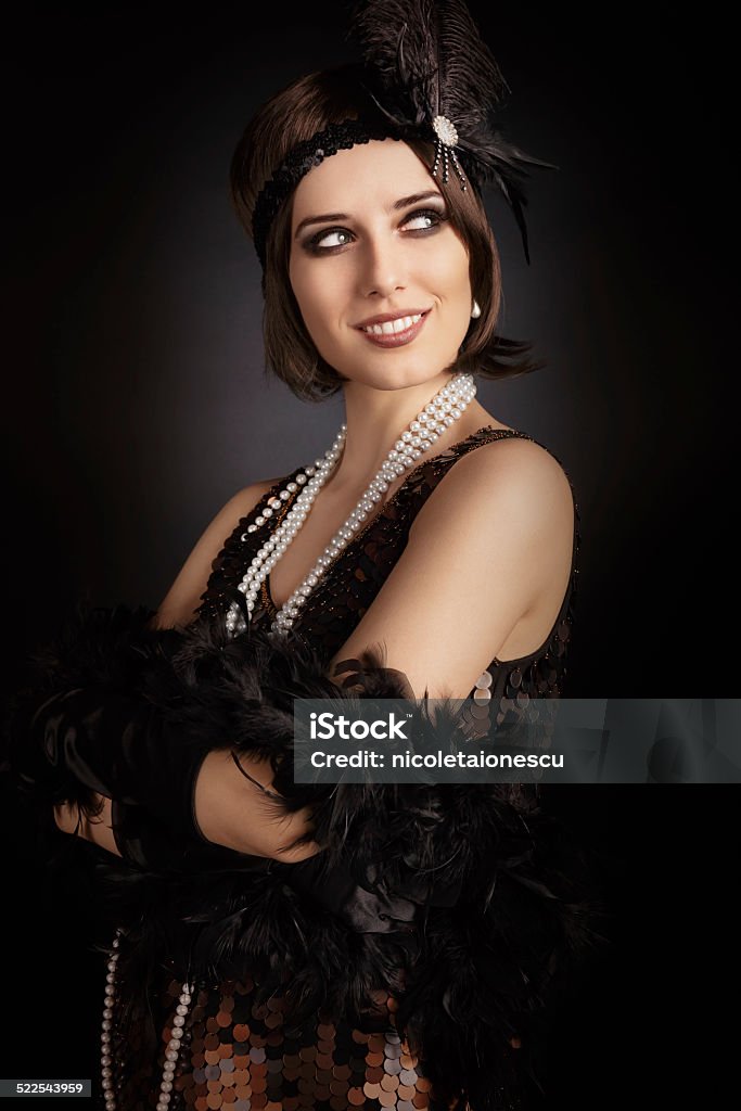 Beautiful retro woman from the roaring 20s ready to party Vintage style image of a flapper girl Flapper Style Stock Photo