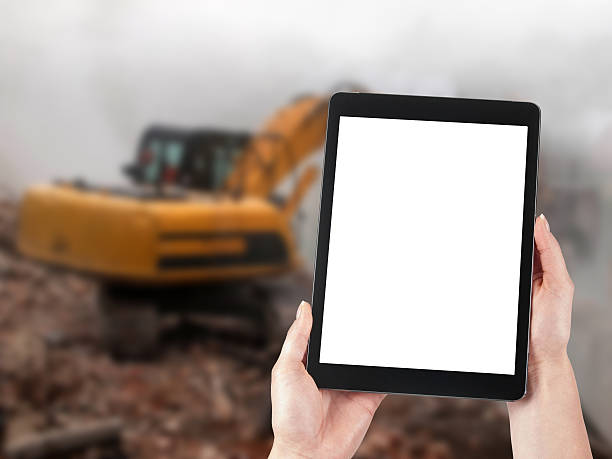 istock Tablet and excavator in the background 522543969