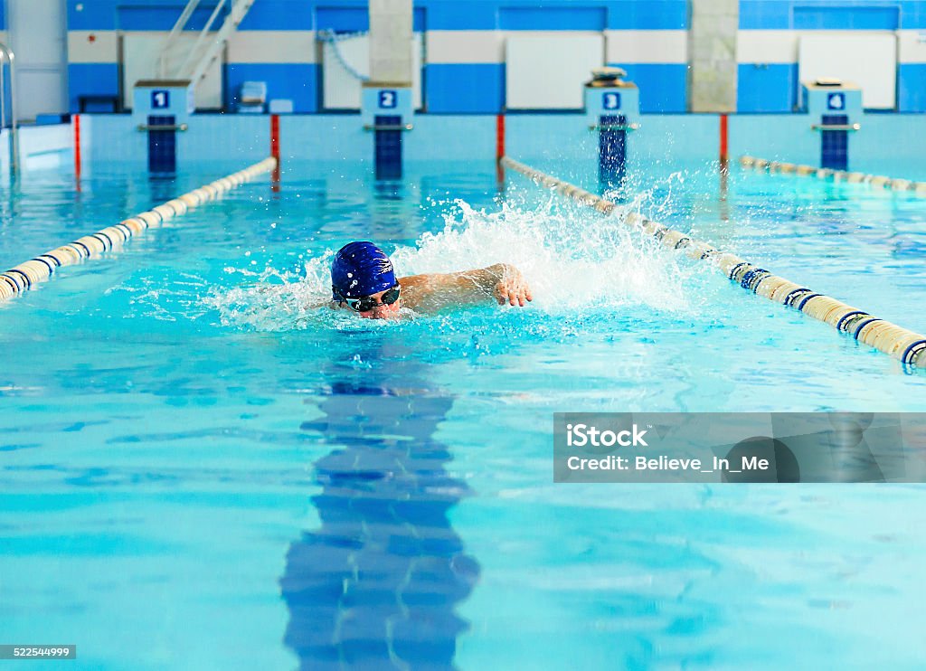 Swimmer Professional male swimmer swimming in the pool Active Lifestyle Stock Photo