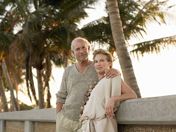 istock Loving Senior Couple Leaning Against Wall On Beach 522545043