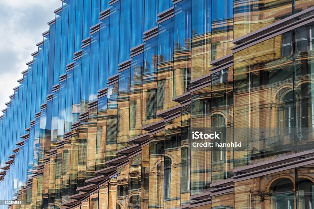 old building facade reflection in modern building glass facade old building facade reflection in modern building glass facade - old building facade, new building exterior Old Stock Photo