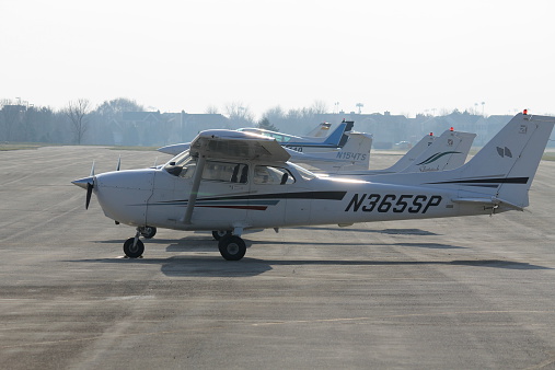 A business jet at an airport taxiing after landing.  