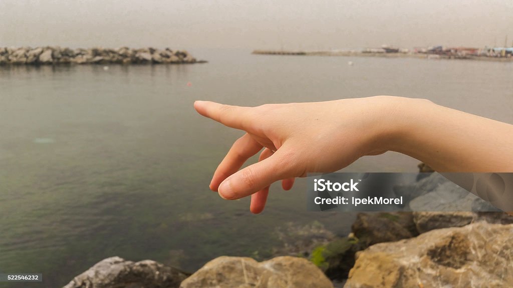 Woman hand pointing up with index finger Adult Stock Photo