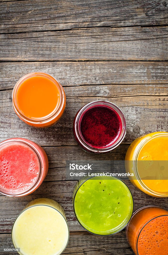 Glasses of fresh juice on wooden table Glasses of fresh juice on an old wooden table Group Of Objects Stock Photo
