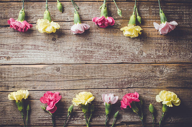 istock Carnation flowers on wooden table 522547986