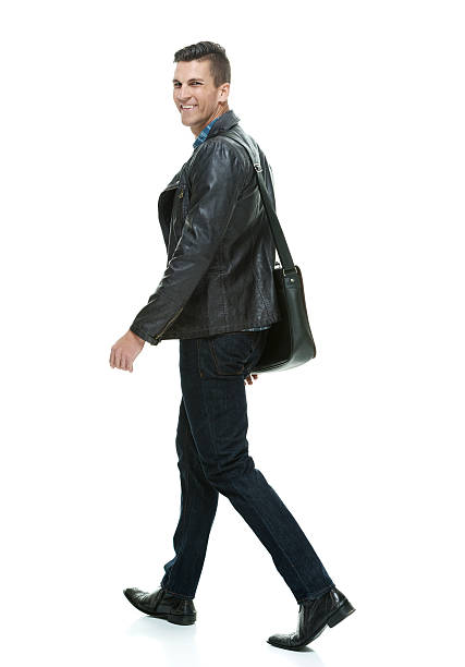 istock Smiling casual man walking and looking at camera 522551960