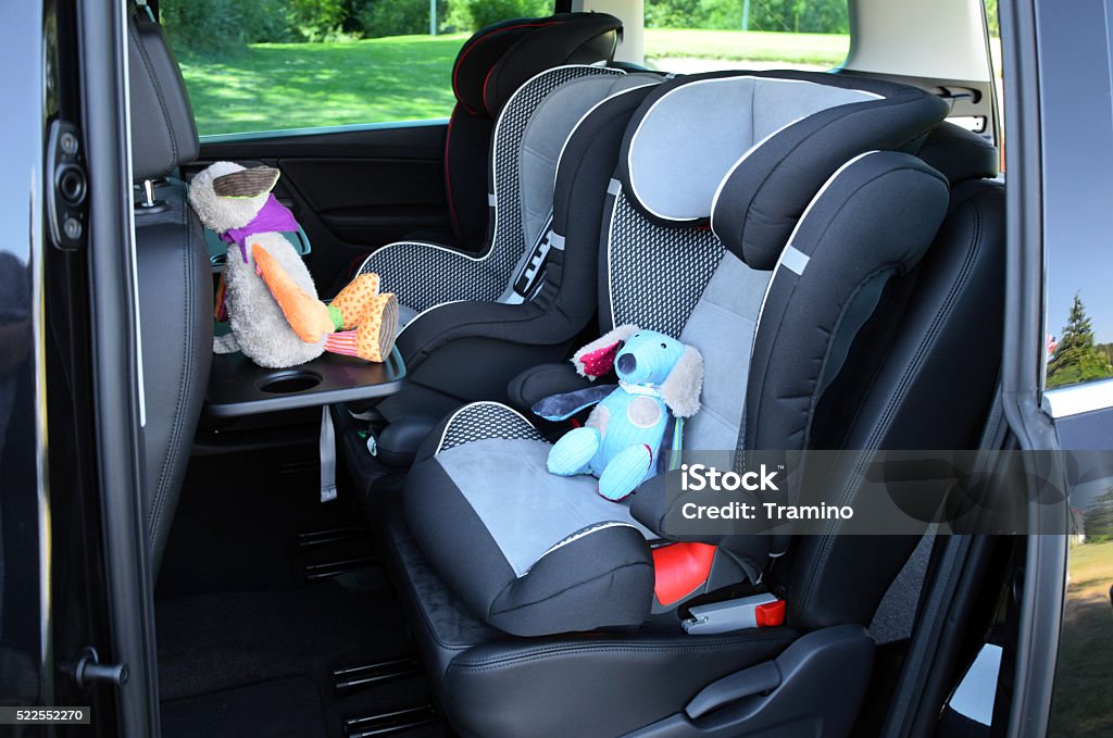 Seats for children in minivan Side shot on the seats for children mounted in minivan. Car Safety Seat Stock Photo
