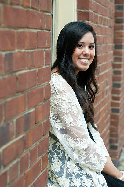 istock Attractive teen sitting in window 522552802