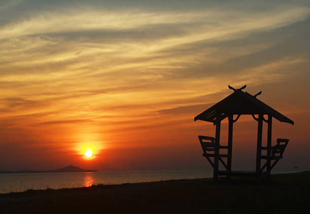 istock blur of beuatiful sunset background with a little hut 522552960