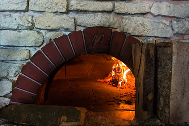 istock fire in the oven.  Traditional Pizza oven 522553114