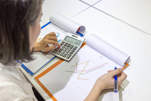 istock Asian office employee checking sales report at workplace 522553904