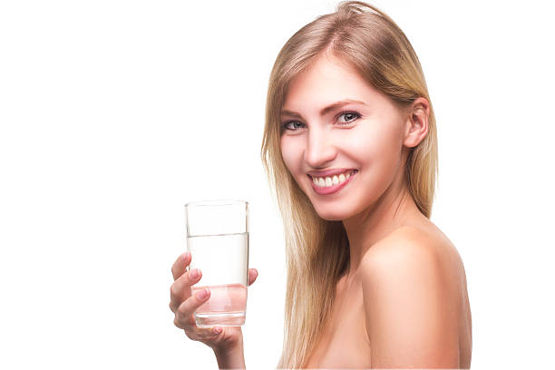 istock blonde with a glass of water 522553912