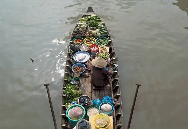 Photo of the woman in floating market Cai Rang, Can Tho