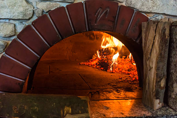 istock fire in the oven.  Traditional Pizza oven 522556360
