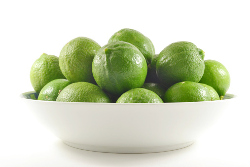 fresh green lemons in bowl