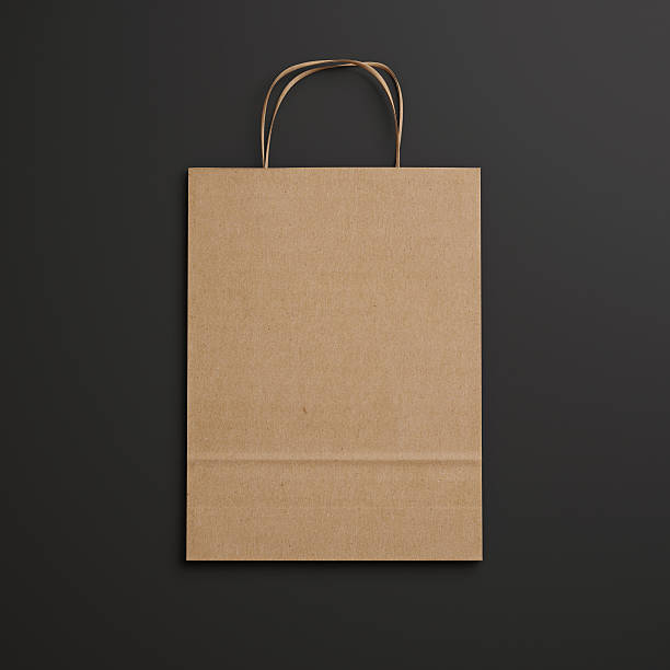 istock Brown paper bag with handles on black background 522563701