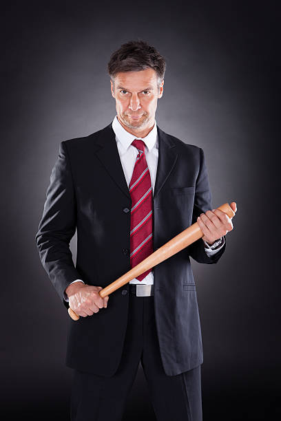istock Businessman Holding Baseball Bat 522564625