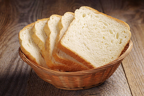 Toast bread Toast bread in wicker basket on old wooden table WHITE BREAD stock pictures, royalty-free photos & images