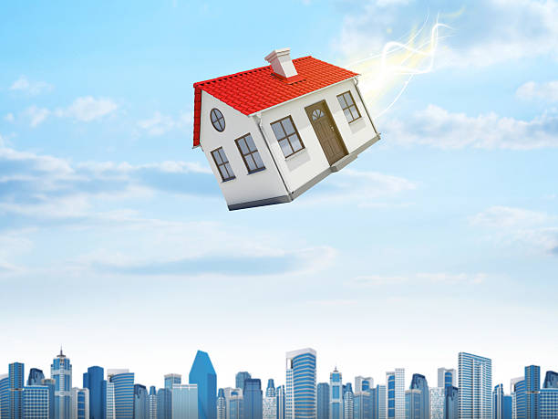istock House is falling from the sky. City on background 522566731