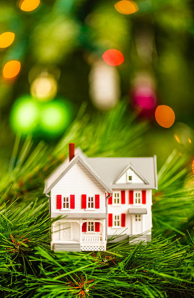 istock New home nestled amongst pine branches of Christmas tree 522578135
