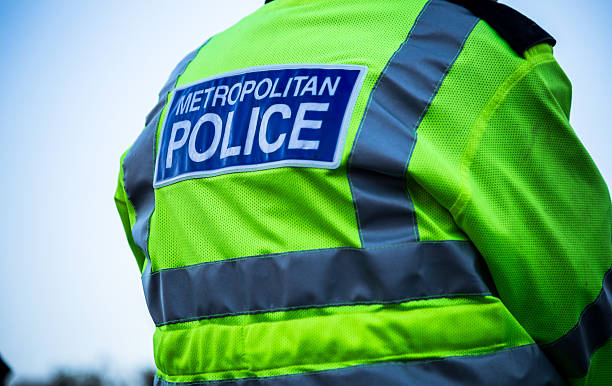 Metropolitan Police Officer Back view of a metropolitan police officer. metropolitan police stock pictures, royalty-free photos & images