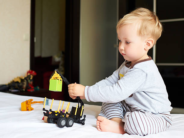 istock Little blond boy playing with car. 522580317