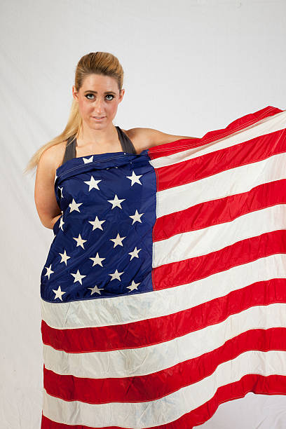 istock Blond woman wrapped in U.S. Flag 522583527