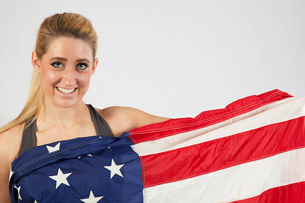 istock Blond woman wrapped in U.S. Flag 522583531
