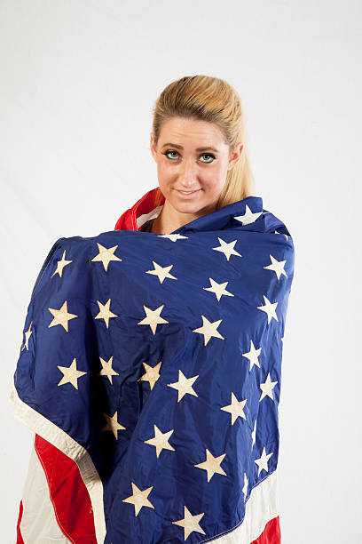 istock Blond woman wrapped in U.S. Flag 522583539