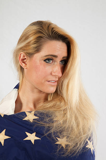istock Blond woman wrapped in U.S. Flag 522583545