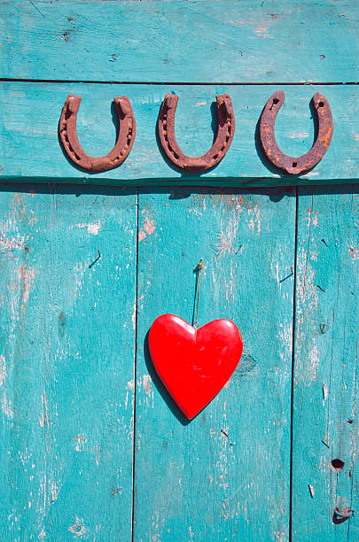 istock three  rusty horseshoe luck symbol and red heart on door 522599823