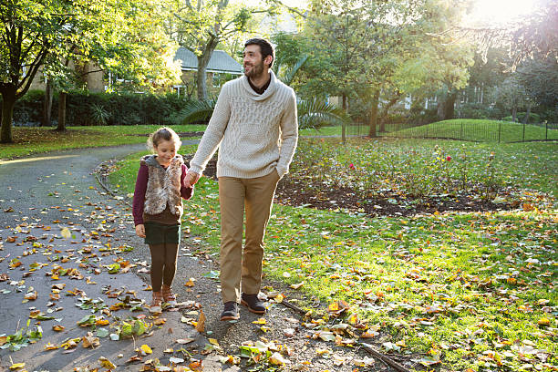 istock father and daughter having a walk outdoors in autumn 522599905
