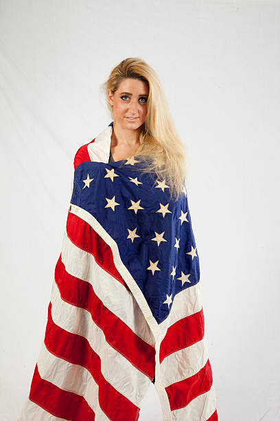 istock Blond woman wrapped in U.S. Flag 522599913