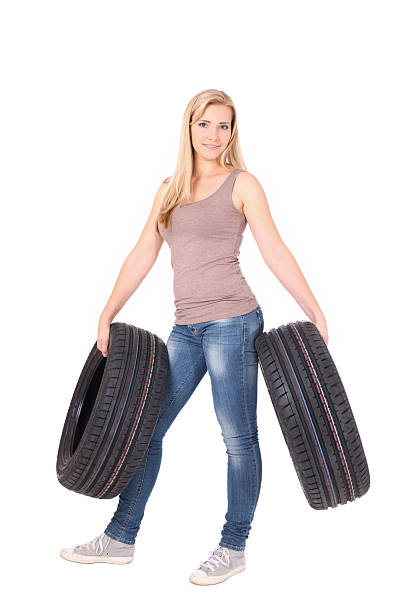 istock Beautiful woman holding tyres. 522603039