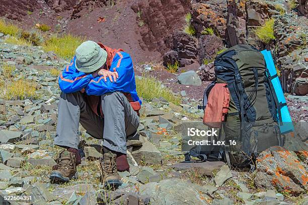 Trekker Resting In Height Mountain Stock Photo - Download Image Now - Illness, High Up, Mountain