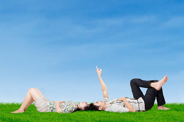 istock Happy couple pointing at the sky 522604557