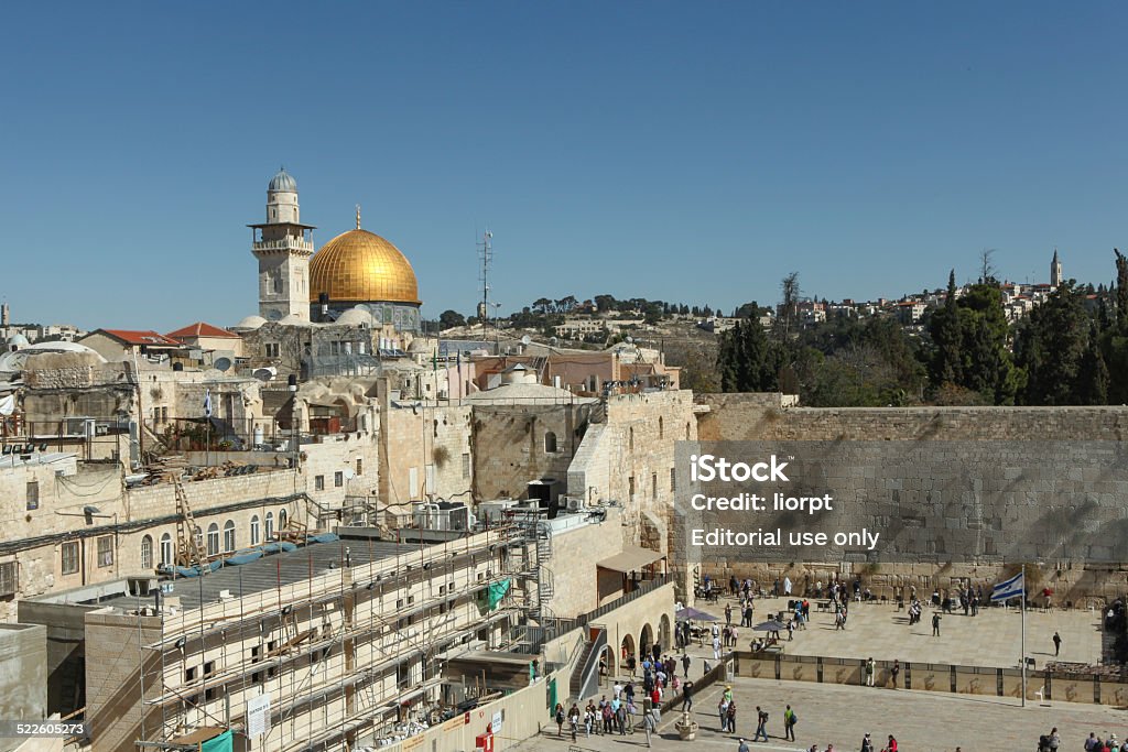 Panoramic view of the wailing wall - Jerusalem, Israel. Jerusalem, Israel - November 9, 2014 : Panoramic View of Jerusalem's westren wall known also as The wailing wall, with tourists and dome of the rock in the background. with people. Architectural Dome Stock Photo