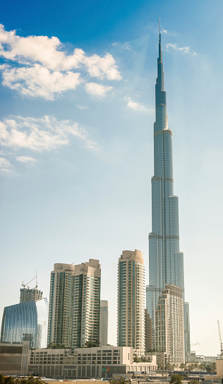 Dubai, UAE - November 3, 2014: Wide view of the new Dubai skyline downtown district around the tallest world building the Burj Khalifa tower, the tallest building of the world, Image taken from the metro station. Sunny day.